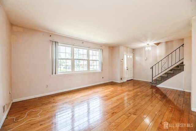 44 Townsend Dr, Old Bridge, NJ 07747 - unfurnished living room with stairway, light wood finished floors, and baseboards