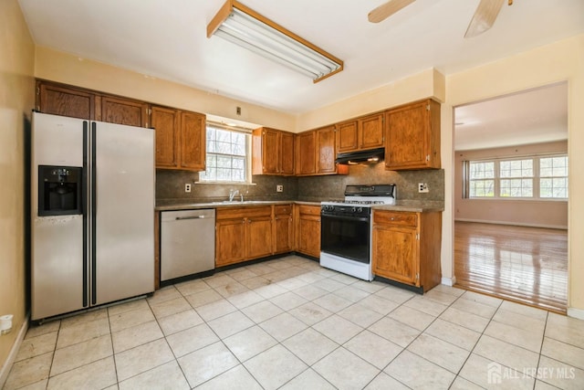 44 Townsend Dr, Old Bridge, NJ 07747 - kitchen with stainless steel dishwasher, white refrigerator with ice dispenser, gas stove, under cabinet range hood, and backsplash