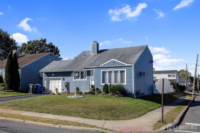 view of front of house featuring a garage and a front lawn