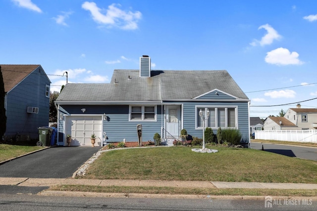 view of front facade with a garage and a front lawn