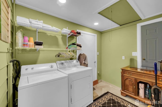 clothes washing area with separate washer and dryer