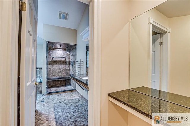 full bathroom with tiled shower and vanity