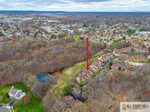 aerial view of property and surrounding area with nearby suburban area