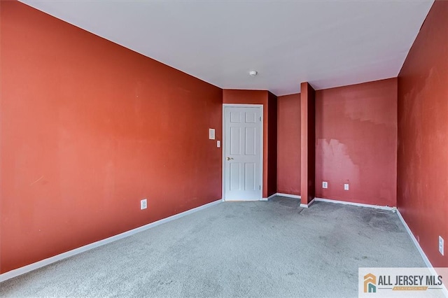 carpeted spare room with baseboards