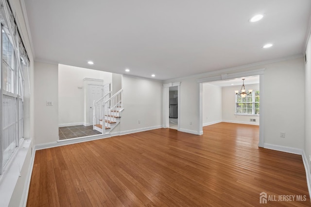 26 Jaime Ct, Old Bridge, NJ 08857 - unfurnished living room featuring wood finished floors, a chandelier, ornamental molding, stairway, and recessed lighting