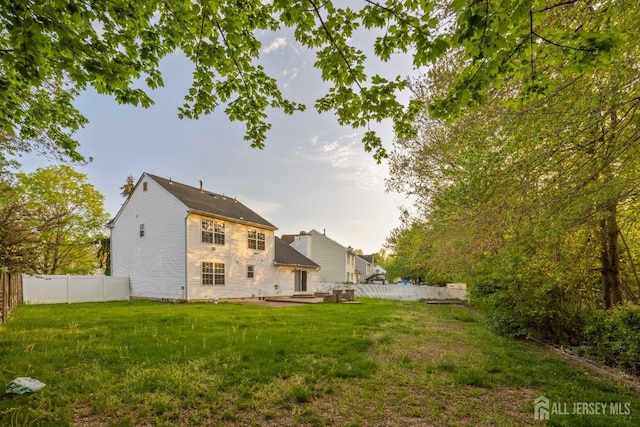 26 Jaime Ct, Old Bridge, NJ 08857 - rear view of house featuring a fenced backyard and a patio area