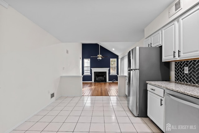 26 Jaime Ct, Old Bridge, NJ 08857 - kitchen with appliances with stainless steel finishes, a ceiling fan, lofted ceiling, a fireplace, and white cabinets