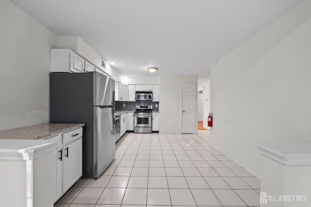 26 Jaime Ct, Old Bridge, NJ 08857 - kitchen featuring tasteful backsplash, stainless steel appliances, white cabinetry, light countertops, and light tile patterned floors
