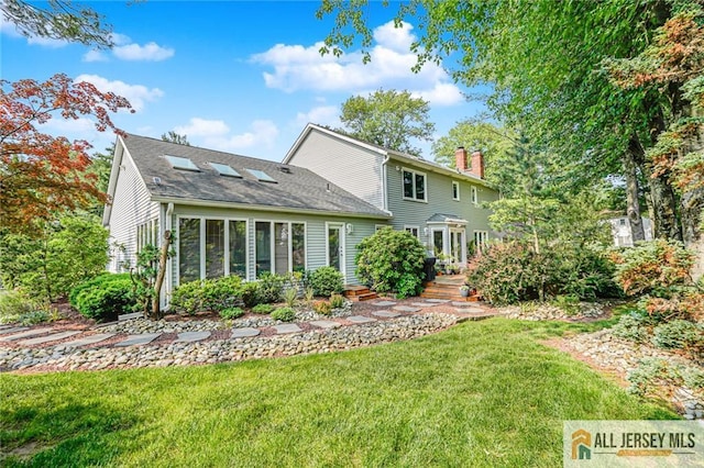 5 Leighton Dr, East Brunswick, NJ 08816 - back of property featuring a chimney, a yard, and a shingled roof