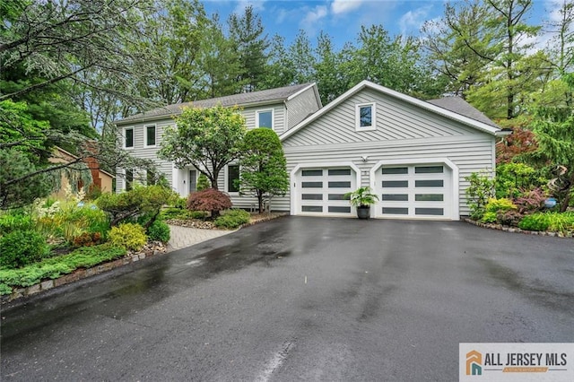 5 Leighton Dr, East Brunswick, NJ 08816 - view of front of property with asphalt driveway and a garage