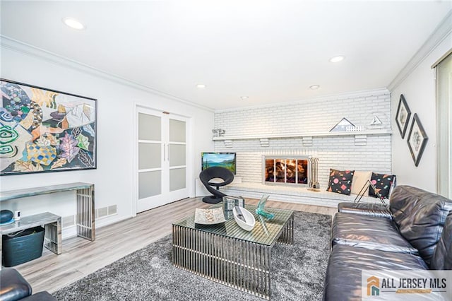 5 Leighton Dr, East Brunswick, NJ 08816 - living area featuring a fireplace, ornamental molding, wood finished floors, brick wall, and recessed lighting