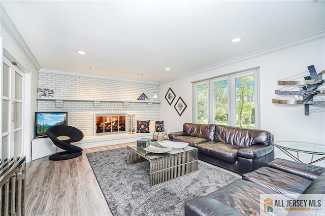 5 Leighton Dr, East Brunswick, NJ 08816 - living area featuring crown molding, brick wall, wood finished floors, a fireplace, and recessed lighting