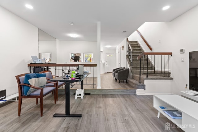 sitting room featuring stairs, wood finished floors, and visible vents