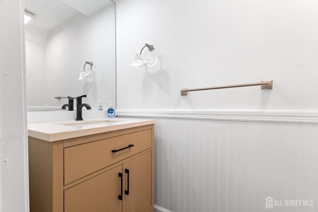 bathroom featuring vanity and a wainscoted wall