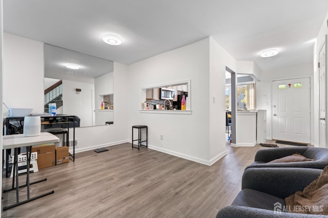 interior space with baseboards and wood finished floors