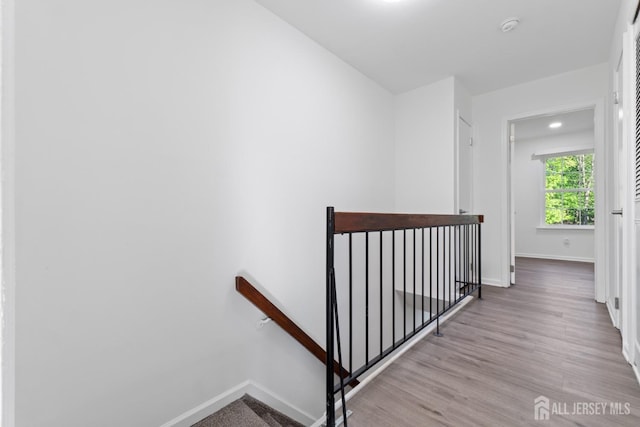 stairway featuring baseboards and wood finished floors