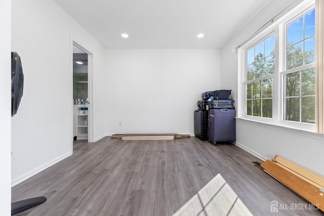 spare room with recessed lighting, baseboards, and wood finished floors