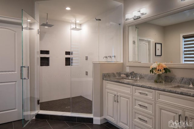 bathroom featuring a shower with door, tile patterned flooring, and double vanity