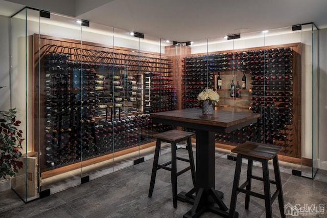 wine room with dark tile patterned floors