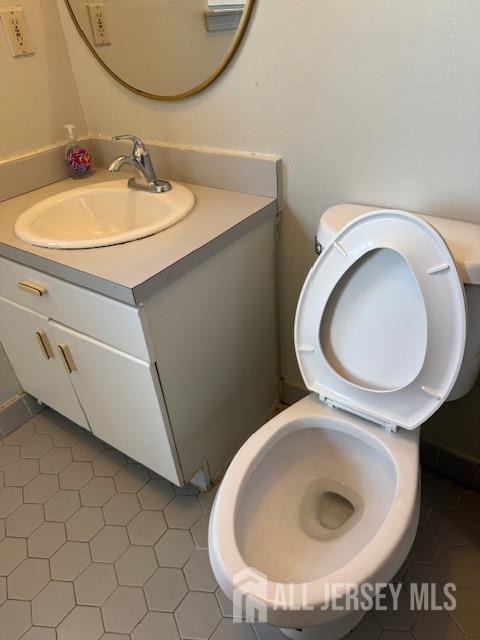 bathroom featuring toilet and vanity