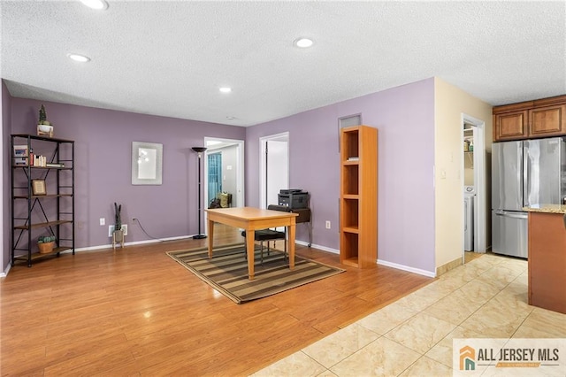 office space with a textured ceiling and light wood-type flooring