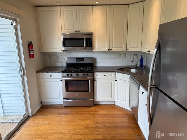 425 Northam Dr, North Brunswick, NJ 08902 - kitchen featuring appliances with stainless steel finishes, white cabinets, decorative backsplash, and recessed lighting