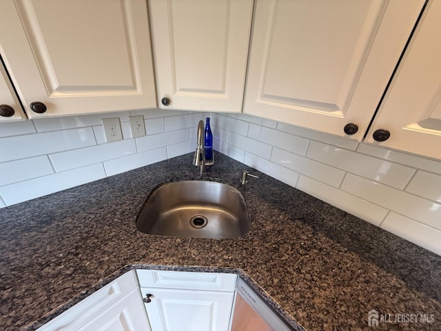 425 Northam Dr, North Brunswick, NJ 08902 - kitchen view of white cabinetry, decorative backsplash, and dark stone counters