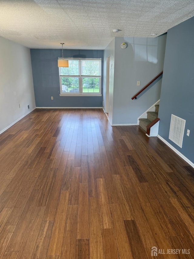 425 Northam Dr, North Brunswick, NJ 08902 - empty room with dark wood-style floors, stairs, and a textured ceiling