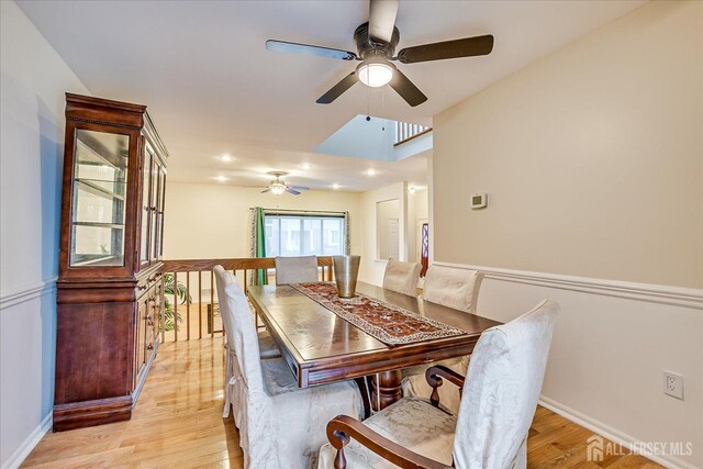 dining area featuring ceiling fan, a skylight, and light hardwood / wood-style flooring