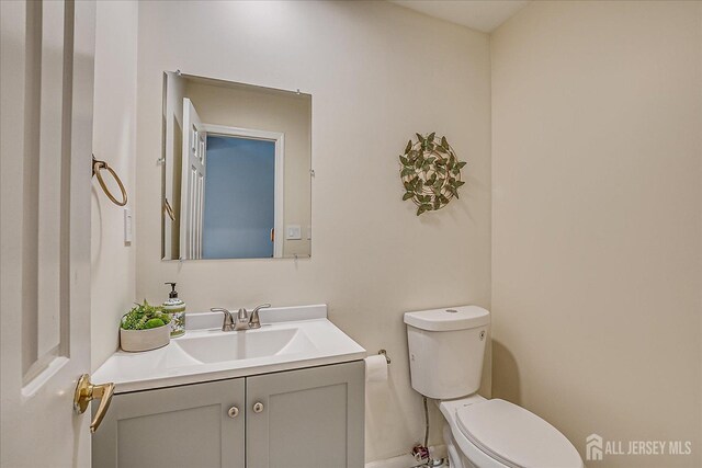 bathroom with toilet and vanity