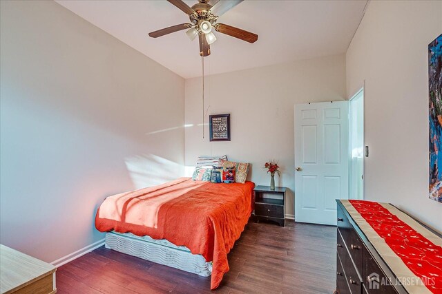 bedroom featuring ceiling fan and dark hardwood / wood-style flooring