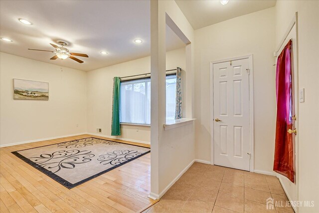 foyer entrance with light wood-type flooring and ceiling fan