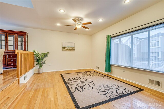 empty room featuring ceiling fan and wood-type flooring