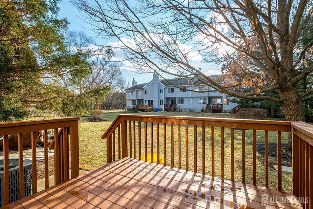 wooden terrace with a lawn