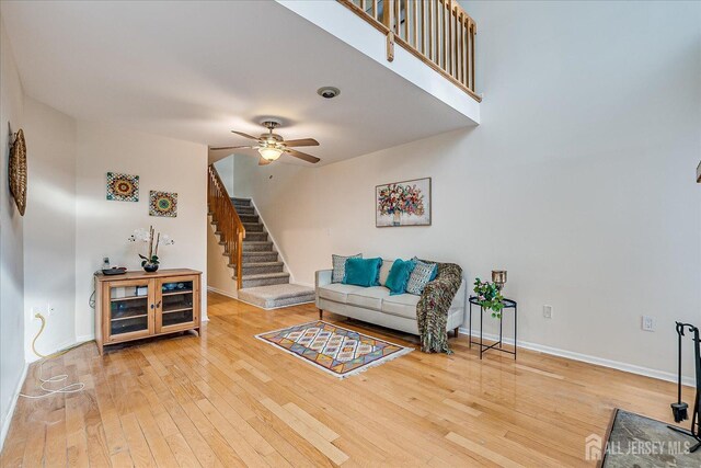 living room featuring ceiling fan and wood-type flooring