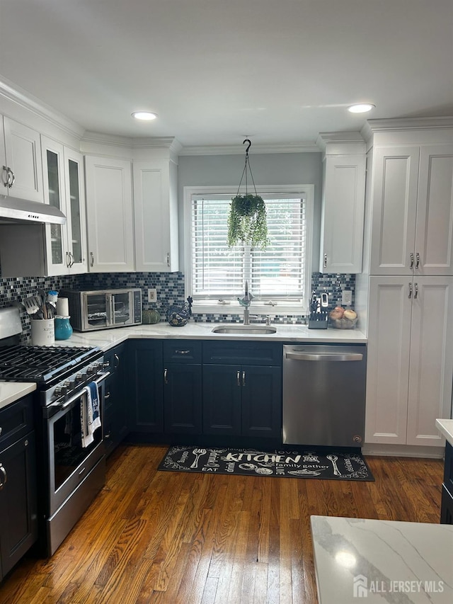 741 Bound Brook Rd, Dunellen, NJ 08812 - kitchen with stainless steel appliances, light countertops, decorative backsplash, ornamental molding, and recessed lighting