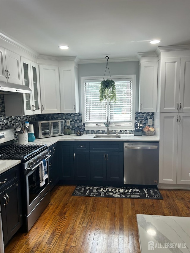 741 Bound Brook Rd, Dunellen, NJ 08812 - kitchen with appliances with stainless steel finishes, white cabinetry, backsplash, light countertops, and dark wood-type flooring