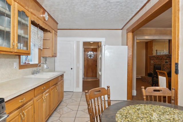 113 Coleman St, Middlesex, NJ 08846 - kitchen featuring freestanding refrigerator, light countertops, ornamental molding, light tile patterned floors, and glass insert cabinets