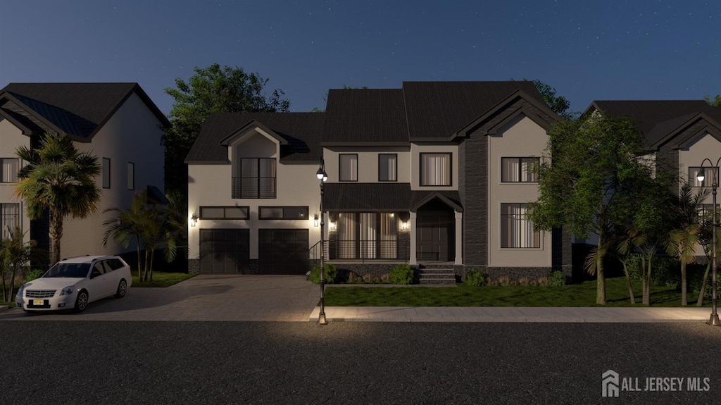 view of front of property with concrete driveway, stucco siding, stone siding, and a garage