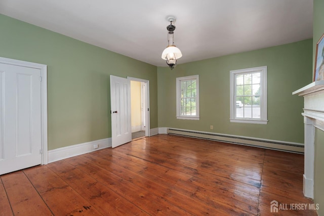 unfurnished dining area with baseboards, a fireplace, baseboard heating, and hardwood / wood-style floors