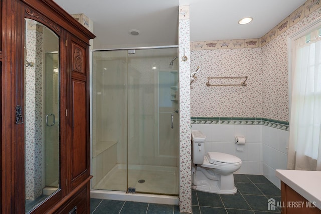 bathroom featuring a stall shower, tile patterned floors, toilet, and wallpapered walls