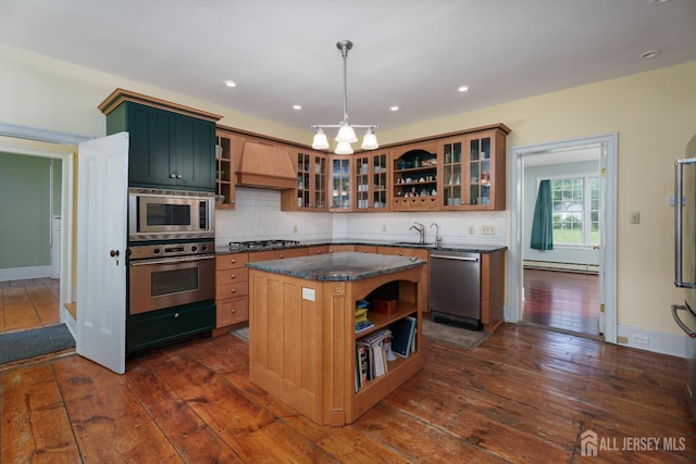 kitchen with open shelves, dark wood-type flooring, a baseboard heating unit, custom range hood, and stainless steel appliances