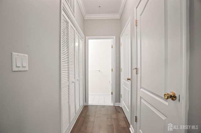 hall with crown molding and hardwood / wood-style flooring