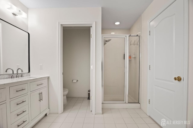 bathroom featuring tile patterned flooring, an enclosed shower, vanity, and toilet