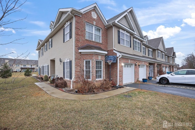 view of front of house with a garage and a front lawn