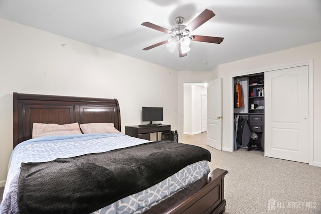 bedroom featuring light colored carpet, a closet, and ceiling fan