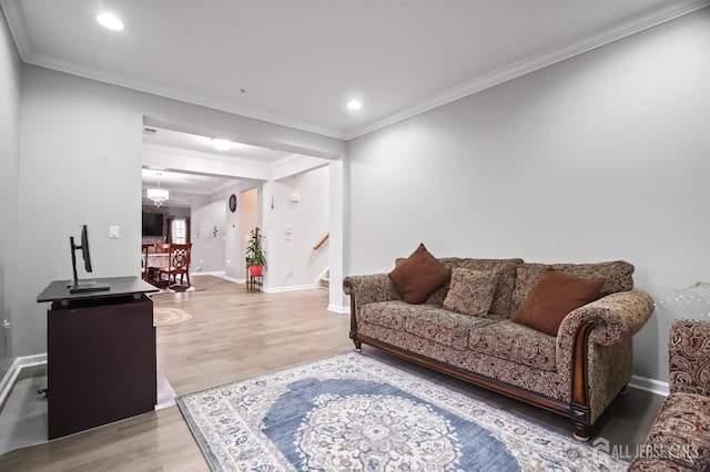 living room featuring hardwood / wood-style flooring and ornamental molding