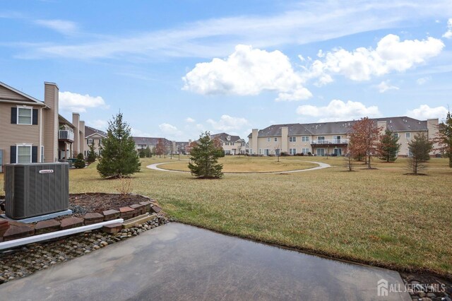 view of yard with a patio area and central air condition unit