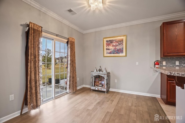 unfurnished dining area featuring crown molding and light hardwood / wood-style flooring