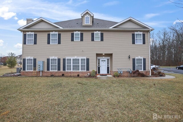 colonial-style house with a front lawn